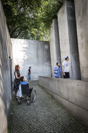 DEU Germany Germany Berlin Disabled tourist in a wheelchair explores Berlin with a city guide.
