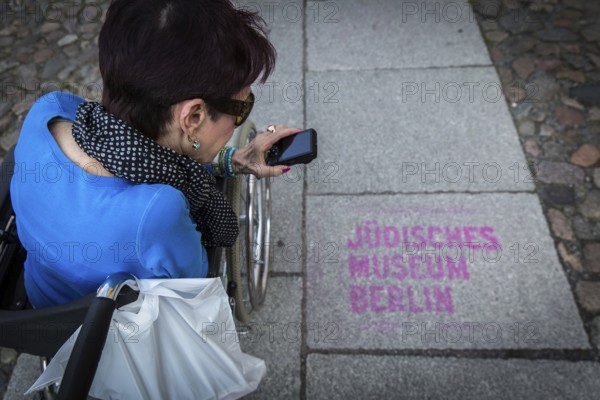 DEU Germany Germany Berlin Disabled tourist in a wheelchair explores Berlin with a city guide.