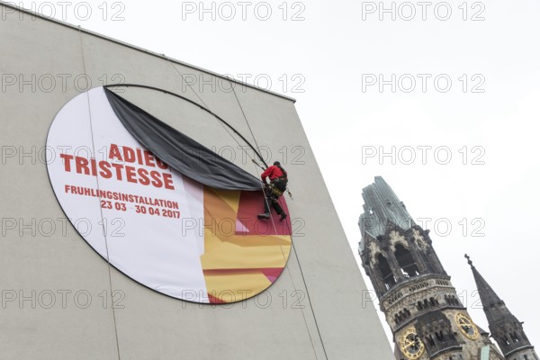 DEU Germany Germany Berlin A worker removes the outdoor advertising for a spring installation in