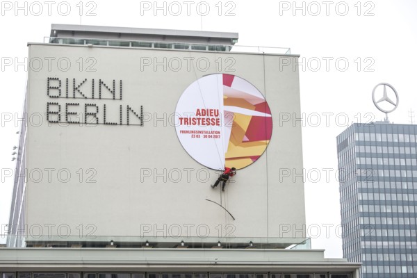 DEU Germany Germany Berlin A worker removes the outdoor advertising for a spring installation in
