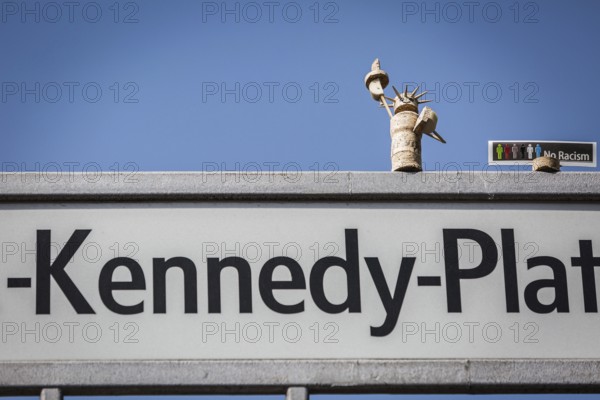 DEU Germany Germany Berlin A freedom statue made of cork stands on the street sign on J.F