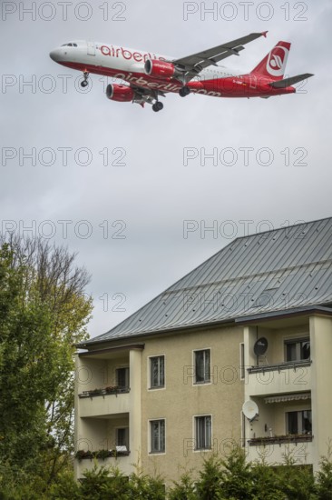 DEU Germany Germany Berlin Landing approach of an Air Berlin aircraft over residential buildings at