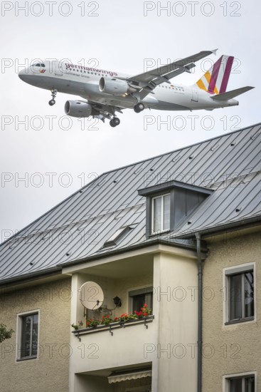 DEU Germany Germany Berlin Landing approach of a German Wings aircraft over residential buildings