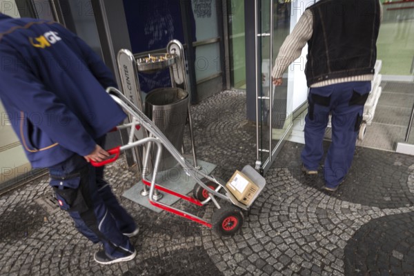 DEU Germany Germany Berlin A courier with grocery orders enters the Europe Centre while a parcel