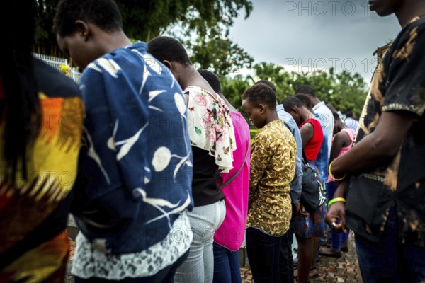 RWA RWANDA RUANDA Kigali A youth group stands in front of a mass grave at the genocide memorial
