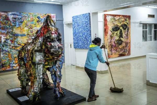 RWA RWANDA RUANDA Kigali A cleaning lady mops during the party at the Inema Gallery. Artists,