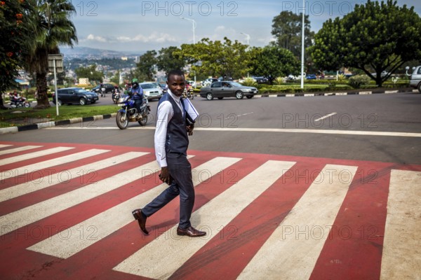 RWA RWANDA RUANDA Kigali A pedestrian in a suit crosses a zebra crossing in the banking district of