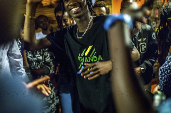 RWA RWANDA RUANDA Kigali Guests at a regular party organised by the Inema Gallery. Artists, locals