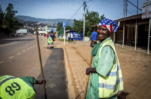 RWA RWANDA RUANDA Kigali Street cleaners clean a road leading to the Genocide Memorial on the