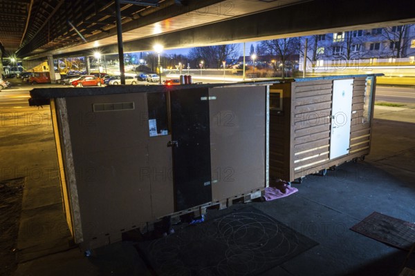 DEU Germany Germany Berlin Wooden shacks financed by donations stand under the motorway bridge in