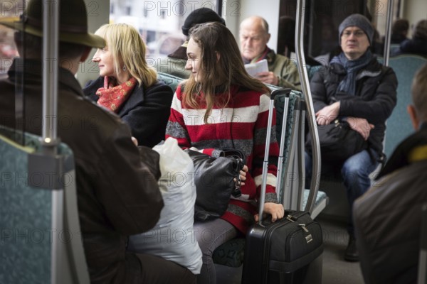DEU Germany Germany Berlin Scenes in and around the S-Bahn.woman holding her suitcase while