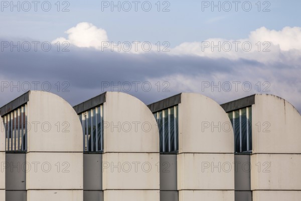 DEU Germany Germany Berlin The towers of the Bauhaus Museum are lined up against a cloudy sky. The