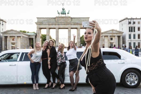 DEU Germany Germany Berlin Young woman pose with a rented stretch limousine in front of the