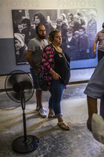 POL Poland Poland Auschwitz Visitors view photos of the Holocaust at the memorial site of the