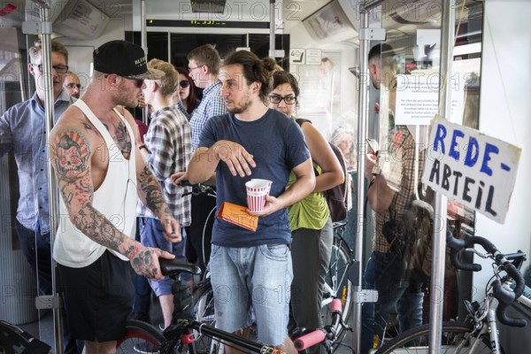 DEU Germany Germany Berlin Students discuss the G20 summit on the Berlin S-Bahn. A loose group of
