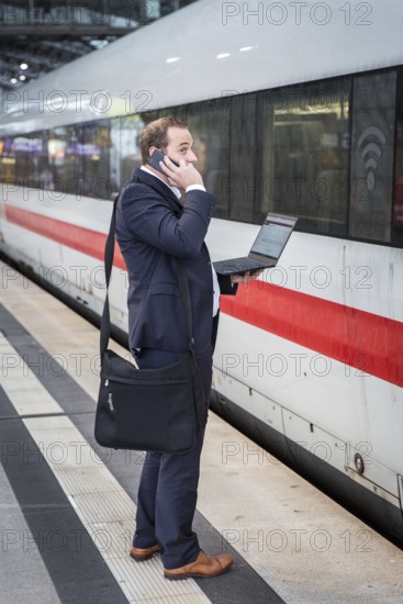 DEU Germany Germany Berlin A passenger stands in front of an ICE train at Berlin Central Station