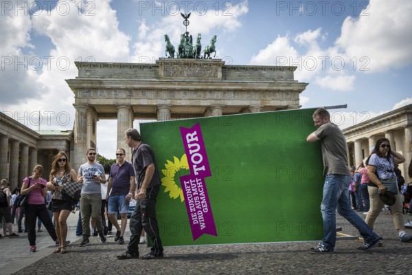 DEU Germany Germany Berlin Two men carry a Green Party billboard across Pariser Platz. After a