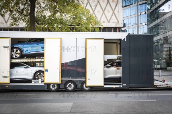 DEU Germany Germany Berlin SUVs with electric motors are loaded onto a transporter in Kantstrasse.