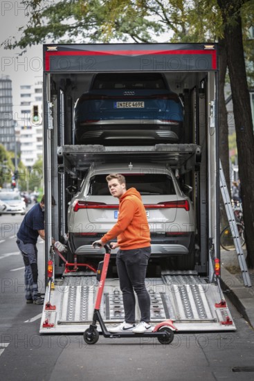 DEU Germany Germany Berlin SUVs with electric motors are loaded onto a transporter in Kantstrasse.