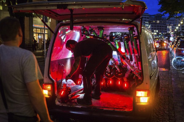 DEU Germany Germany Berlin So-called juicers collect discharged electric scooters at Potsdamer