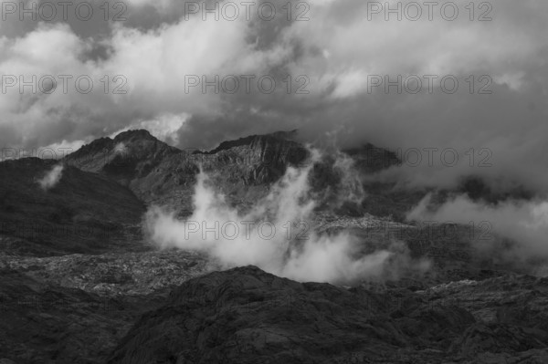 View over the Steinernes Meer Plateau to the summit of the Funtenseetauern with moving clouds,