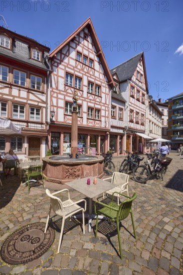 Marienbrunnen, stone fountain, historic half-timbered houses, buildings, bicycles, square made of