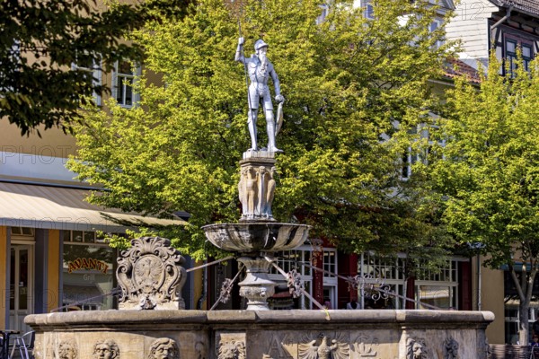 Fountain with an impressive warrior statue in a municipal park with trees, statue and memorial in