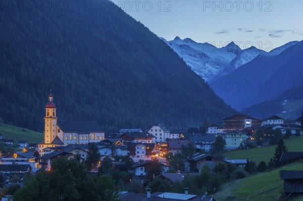 View of town with mountains and Stubai glacier at dusk, Neustift im Stubai Valley, Stubai Valley,