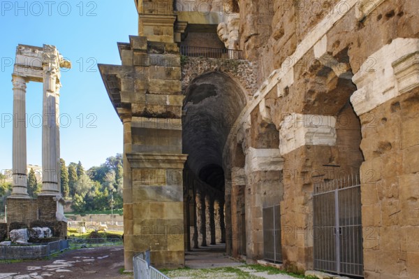 Center and right part of preserved façade of historic ancient Marcellus Theatre, left ruin of