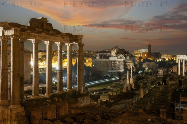 Night view photo at dusk evening view of Roman Forum, left column ruin remains of Temple of Saturn,