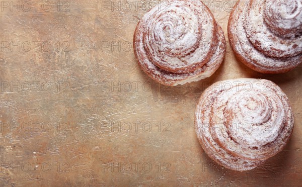 Bakery product, lemon twist, with white glaze, sweet bun, muffin, pastries, top view, no people