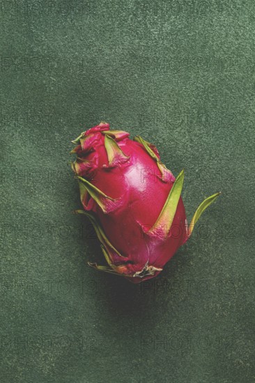 Dragon fruit, pitahaya, one piece, top view, rustic style, green background