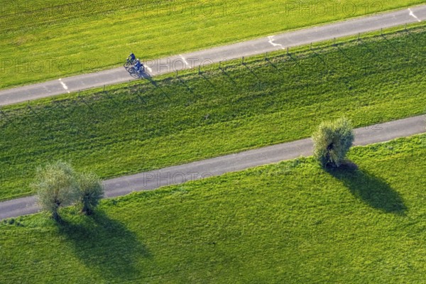 Aerial view, cycle path and cyclist in the foothills of the Rhine Perrich, green meadows and green