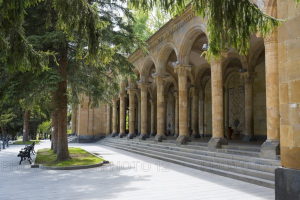 Arch making in a park with stone arches and tall trees in sunny weather, Mineral Water Gallery in