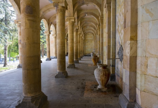 Spacious portico with jugs and symmetrical stone arches that combine historical flair with natural