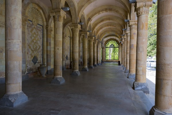 Historic colonnade with symmetrical stone arches in a cool interior, Mineral Water Gallery in