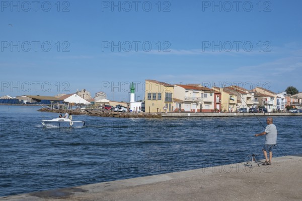 An angler looks from the banks of the Canal de Sete, formerly Canal Royal, across to the
