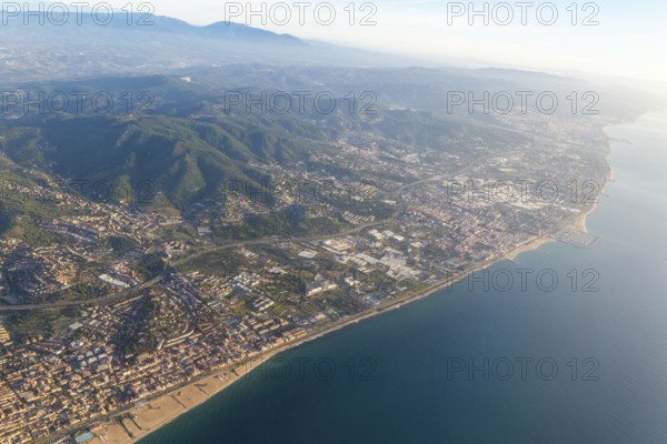 Oblique aerial view of settlements on coastal plain and hillsides, Mediterranean Sea coast, El