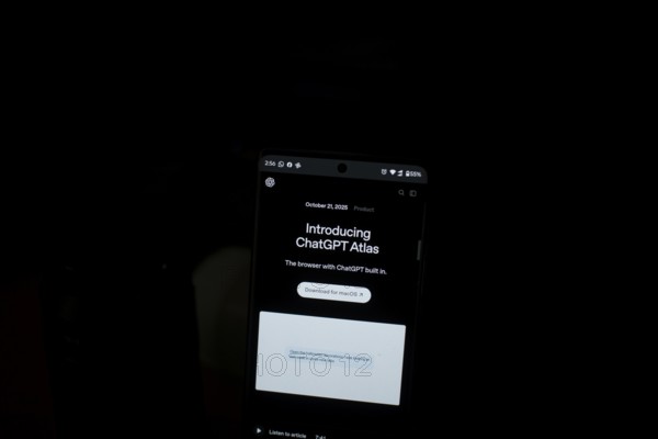 Smartphone displaying ChatGPT Atlas text in a dark setting