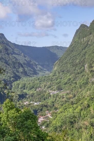 View from Department 52 of the massive, steep Remparts rock faces of Cirque du Salazie and a hamlet