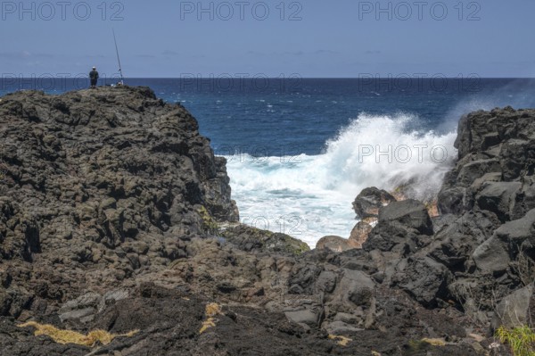 Thundering surf washes around the black lava cliffs of the south coast of the Indian Ocean, very