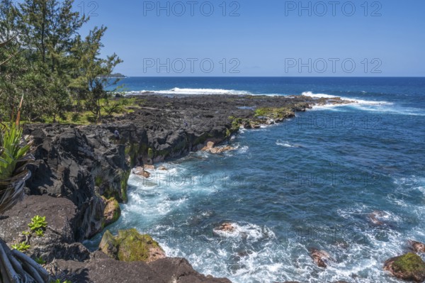 The black lava coast near the Marine de Vincendo offers a wide view of the deep blue Indian Ocean,