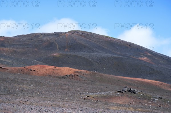 The Route du Volcan leads through the vast, black volcanic desert of the Plaine des Sables, where a