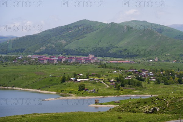 Village in green hills with lake and mountains in the background, Kechut, Kushchi, Kush-Bilyak, and