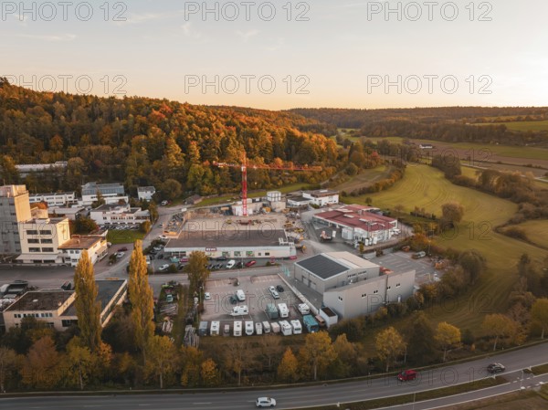 Industrial plant surrounded by autumn trees and fields in the evening, Aidlingen, Böblingen