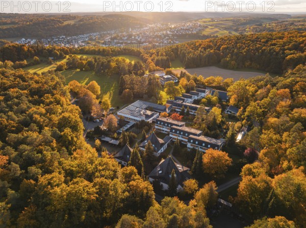 Motherhouse buildings and autumn trees in rural area at sunset, Aidlingen, Böblingen district,