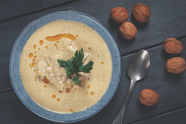 Satsivi, Georgian dish, chicken in nut sauce, cold appetizer, on a wooden table, no people,