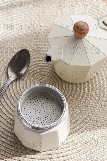 Geyser coffee maker, empty and clean, disassembled on the table, coffee preparation, sunlight,