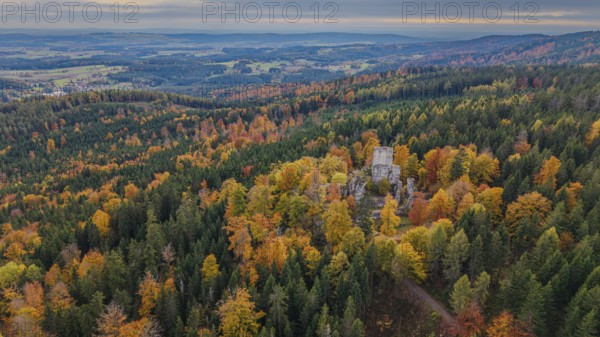 In the beautiful autumn landscape, the remains of the Weissenstein castle ruins stand in the middle
