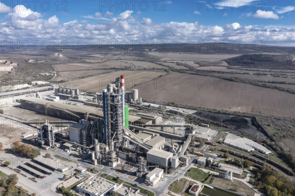 Aerial view of a sprawling industrial complex with rural fields in the background. Aerial view to